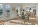 Cozy dining area with views of the water and a stylish table set, complemented by natural light and tile flooring at 634 Key Royale Dr, Holmes Beach, FL 34217