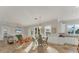 Open dining area with a view of the living room and kitchen, tile floors, and natural light from the windows at 634 Key Royale Dr, Holmes Beach, FL 34217