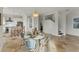 Inviting dining area offering seamless access to the kitchen and living room, featuring tile floors and modern lighting at 634 Key Royale Dr, Holmes Beach, FL 34217