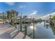 A picturesque waterfront view from the dock, showcasing the tranquil canal and boat lifts at 634 Key Royale Dr, Holmes Beach, FL 34217