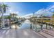 A picturesque waterfront view from the dock, showcasing the tranquil canal and boat lifts at 634 Key Royale Dr, Holmes Beach, FL 34217