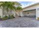 A charming two-story home with a spacious garage and a well-manicured yard provides curb appeal at 634 Key Royale Dr, Holmes Beach, FL 34217