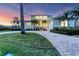 Inviting two-story home with meticulous landscaping and a paved driveway enhances its curb appeal at 634 Key Royale Dr, Holmes Beach, FL 34217