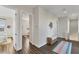 Spacious hallway with wood floors, ample lighting, a woven bench, and views into other rooms at 634 Key Royale Dr, Holmes Beach, FL 34217