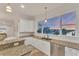 Well-lit kitchen featuring granite countertops, stainless steel appliances, and a large window with waterfront views at 634 Key Royale Dr, Holmes Beach, FL 34217