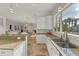 Kitchen with granite counters and stainless sink overlooking an open living and dining area at 634 Key Royale Dr, Holmes Beach, FL 34217