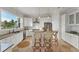 Bright kitchen features an island with bar seating, stainless steel appliances, granite counters, and ample cabinetry at 634 Key Royale Dr, Holmes Beach, FL 34217