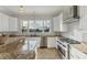Bright kitchen features stainless steel appliances, granite counters, and a large window with tropical views at 634 Key Royale Dr, Holmes Beach, FL 34217