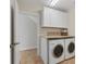 Convenient laundry room featuring a washer and dryer, cabinets for storage, and a neutral color scheme at 634 Key Royale Dr, Holmes Beach, FL 34217