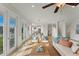 Bright and open living room with tile floors, comfortable furniture, and access to outdoor space, perfect for relaxation at 634 Key Royale Dr, Holmes Beach, FL 34217