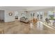 Spacious living room featuring tile floors, a comfortable sofa, and access to an outdoor balcony at 634 Key Royale Dr, Holmes Beach, FL 34217