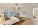 Serene main bedroom with tiled floor, ceiling fan, waterfront view and direct access to the balcony at 634 Key Royale Dr, Holmes Beach, FL 34217