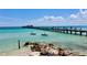 Picturesque scene of a pier extending into turquoise waters, capturing the beauty of a coastal location at 634 Key Royale Dr, Holmes Beach, FL 34217