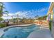 Sparkling swimming pool with clear blue water, overlooking a scenic canal and palm-tree-lined landscape at 634 Key Royale Dr, Holmes Beach, FL 34217