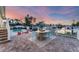 Inviting poolside area featuring a dining table, outdoor seating, and beautiful waterfront views at 634 Key Royale Dr, Holmes Beach, FL 34217