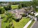 Aerial view featuring a home with solar panels, screened pool, and an inviting landscaped yard at 6405 Alesheba Ln, Sarasota, FL 34240