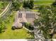 Clear aerial view of a home with solar panels, an enclosed pool, and well-kept landscaping at 6405 Alesheba Ln, Sarasota, FL 34240