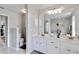 Bright bathroom features dual sinks, a large mirror, and modern fixtures and finishes at 6405 Alesheba Ln, Sarasota, FL 34240