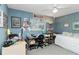 Well-lit bedroom featuring a desk, a comfortable bed, and decoratively painted walls at 6405 Alesheba Ln, Sarasota, FL 34240