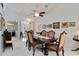 Formal dining room features a dark wood table, upholstered chairs, and decorative wall art at 6405 Alesheba Ln, Sarasota, FL 34240