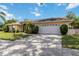 Charming single-story home featuring a two-car garage, well-manicured lawn, and beautiful landscaping at 6405 Alesheba Ln, Sarasota, FL 34240
