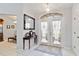 Inviting foyer with tiled floor, arched window, and decorative mirror creating an elegant entryway at 6405 Alesheba Ln, Sarasota, FL 34240