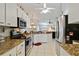 Bright kitchen features stainless steel appliances, granite countertops, and white cabinetry at 6405 Alesheba Ln, Sarasota, FL 34240