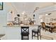 Bright and airy kitchen with white cabinetry, a breakfast bar, and adjacent dining area at 6405 Alesheba Ln, Sarasota, FL 34240