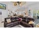 Open-concept living room with views of the kitchen, dining area, and large leather sectional at 6405 Alesheba Ln, Sarasota, FL 34240