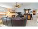 Cozy living room features a brick fireplace, ceiling fan, and comfortable seating area at 6405 Alesheba Ln, Sarasota, FL 34240