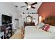 This main bedroom features carpeted floors, a ceiling fan, and an ensuite bathroom at 6405 Alesheba Ln, Sarasota, FL 34240