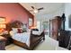 Spacious main bedroom features a decorative bed, a ceiling fan, and access to the patio at 6405 Alesheba Ln, Sarasota, FL 34240