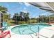 Screened in backyard pool with seating area, lush landscaping, and ample space for entertaining at 6405 Alesheba Ln, Sarasota, FL 34240