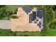 Aerial view of home with solar panels on the roof and screened in pool in landscaped backyard at 6528 Coopers Hawk Ct, Lakewood Ranch, FL 34202