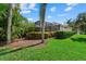 Backyard offers serene views with lush landscaping, a pool and a screened-in lanai at 6528 Coopers Hawk Ct, Lakewood Ranch, FL 34202