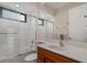 Bright bathroom features a shower-tub combo, a vanity with cabinet, and a large mirror at 6528 Coopers Hawk Ct, Lakewood Ranch, FL 34202