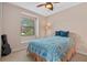 Cozy bedroom with a window seat and a double bed covered with a blue quilt at 6528 Coopers Hawk Ct, Lakewood Ranch, FL 34202