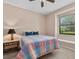 Comfortable bedroom with a colorful quilt, a bedside table, and a window seat at 6528 Coopers Hawk Ct, Lakewood Ranch, FL 34202
