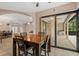 Open dining area with a wooden table set and sliding doors to an outdoor seating area at 6528 Coopers Hawk Ct, Lakewood Ranch, FL 34202