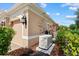 Exterior view of home features a generator and lush landscaping at 6528 Coopers Hawk Ct, Lakewood Ranch, FL 34202