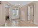 Welcoming foyer with double doors, tile flooring, and a view into the adjacent rooms at 6528 Coopers Hawk Ct, Lakewood Ranch, FL 34202