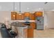 Open kitchen with wood cabinets, a breakfast bar, pendant lighting, and stainless steel appliances at 6528 Coopers Hawk Ct, Lakewood Ranch, FL 34202