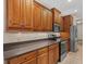 Contemporary kitchen with sleek appliances, wood cabinetry, and ample counter space for cooking at 6528 Coopers Hawk Ct, Lakewood Ranch, FL 34202