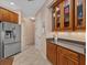 Galley kitchen with stainless steel appliances, dark wood cabinets, and tile floors at 6528 Coopers Hawk Ct, Lakewood Ranch, FL 34202