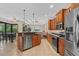 Modern kitchen open to dining and living areas, with stainless appliances and tile flooring at 6528 Coopers Hawk Ct, Lakewood Ranch, FL 34202