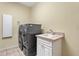 Well-organized laundry room features a sink and modern washer and dryer at 6528 Coopers Hawk Ct, Lakewood Ranch, FL 34202