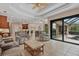 Spacious living room with an open floor plan, tile floors, and views of the outdoor pool at 6528 Coopers Hawk Ct, Lakewood Ranch, FL 34202
