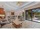 Spacious living room with an open floor plan, tile floors, and views of the outdoor pool at 6528 Coopers Hawk Ct, Lakewood Ranch, FL 34202