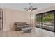 Comfortable living room with a ceiling fan and sliding glass doors overlooking the pool at 6528 Coopers Hawk Ct, Lakewood Ranch, FL 34202