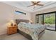 Serene main bedroom with tray ceilings and a large window overlooking the pool at 6528 Coopers Hawk Ct, Lakewood Ranch, FL 34202